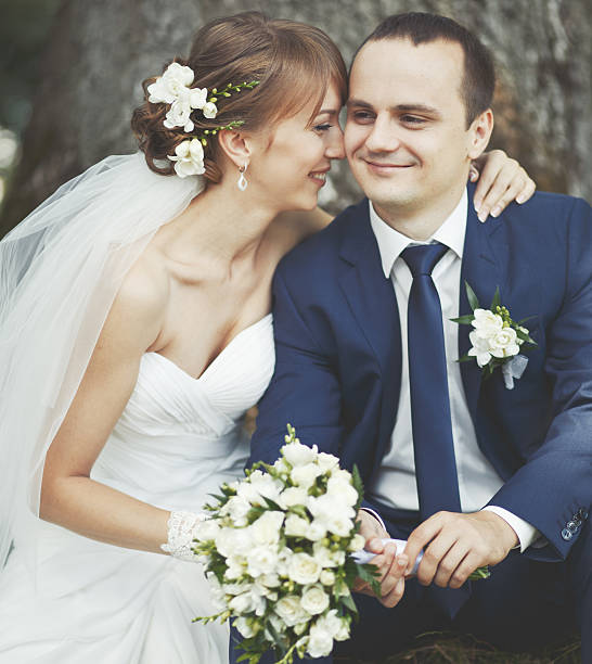 istock Young wedding couple  in park together 463398007