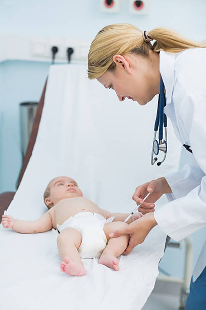 istock Female doctor doing an injection on a baby 463407053