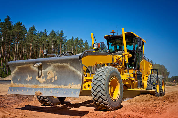 Working yellow Grader at a new highway construction