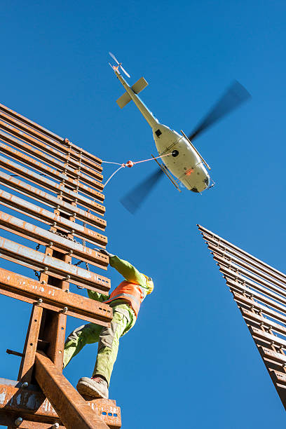 istock helicopter transporting steel wall to mechanic at site 463407333