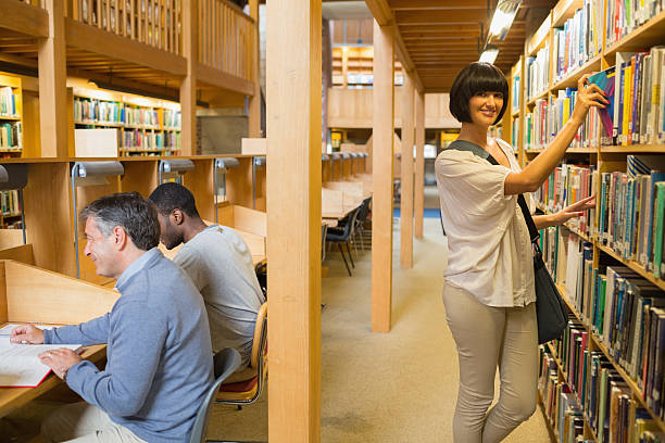istock Woman taking book from shelf 463408089