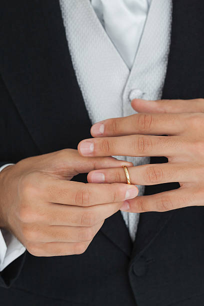 istock Close up of a classy groom trying his wedding ring 463409057