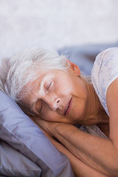 istock Retired woman sleeping in her bed 463409675