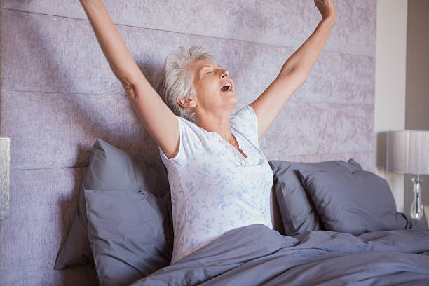 istock Mature woman waking up and yawning 463409695