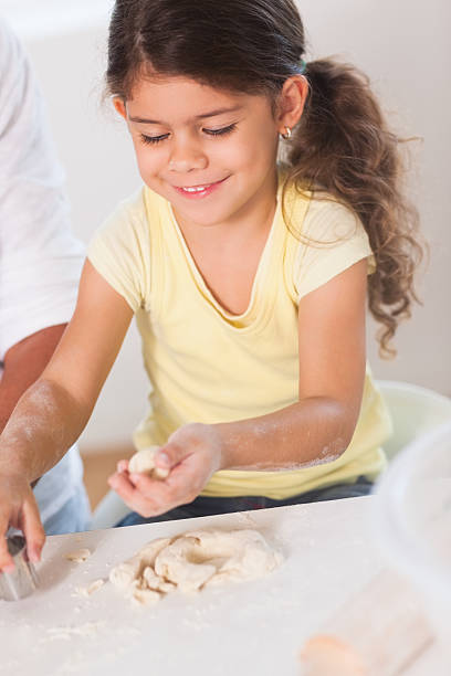 istock Little girl making something with pastry 463411239