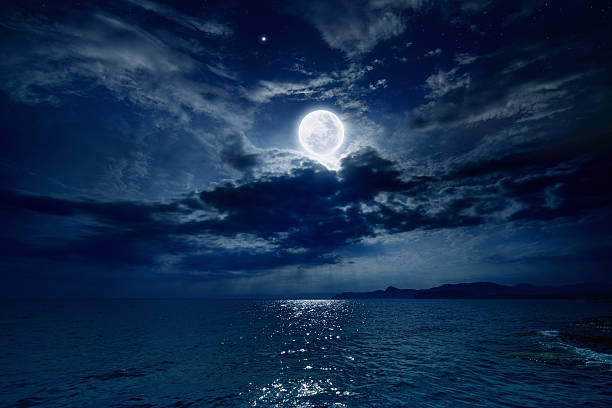 Full moon over sea Night sky with full moon and reflection in sea, stars, beautiful clouds. Elements of this image furnished by NASA horizon over water photos stock pictures, royalty-free photos & images