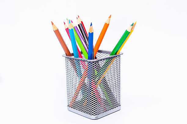 Various color pencils set in black container isolated on white stock photo