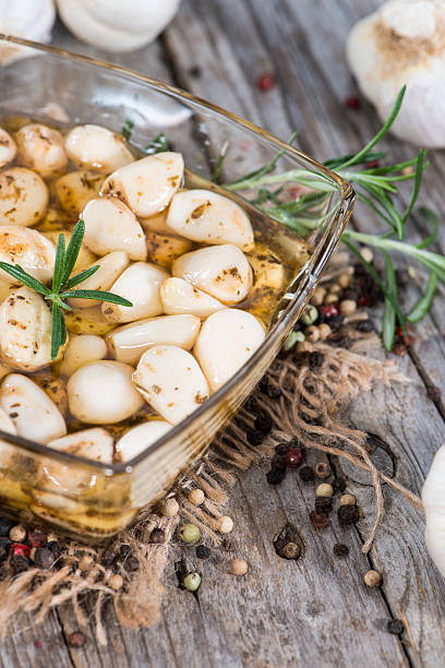 istock Preserved Garlic with fresh herbs 463424803