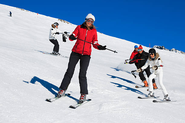 Skiing class on the mountain slope Group of skiiers with the instructor. Skiing class.  Beginner Course - Skiing Stance ski instructor stock pictures, royalty-free photos & images