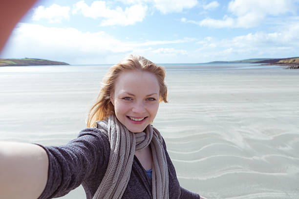 istock Pretty young woman holding the camera 463427713