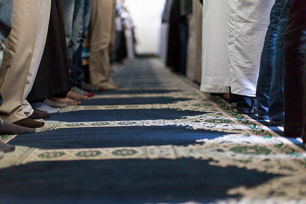 istock Group of muslim men praying together in the mosque. 463428131