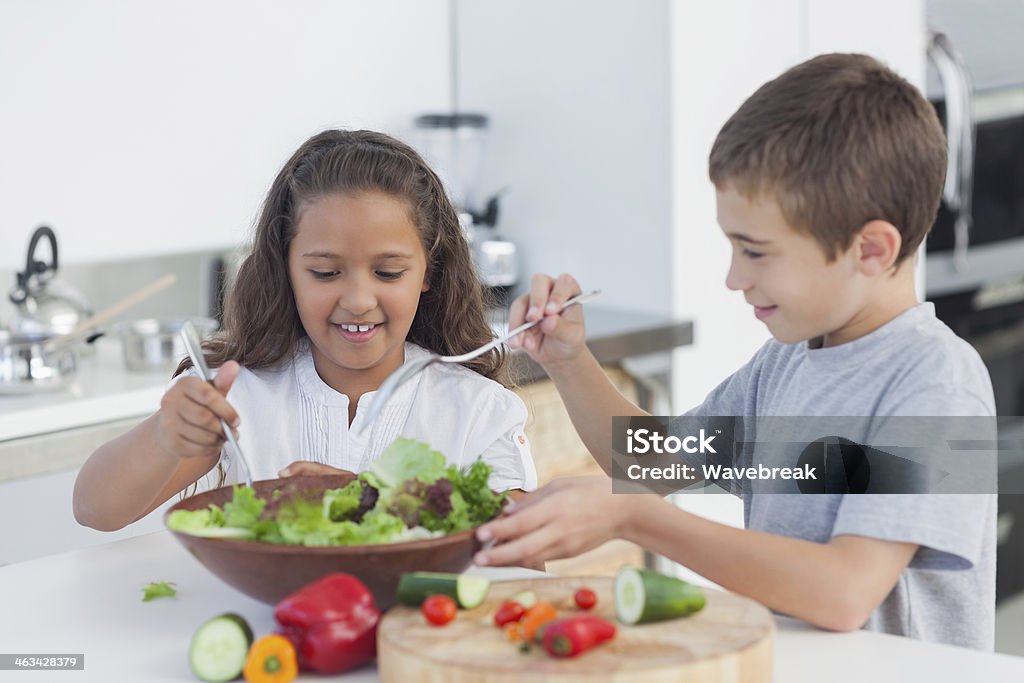 Fratelli preparare un'insalata insieme - Foto stock royalty-free di Alimentazione sana