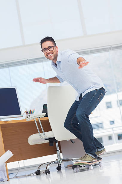 istock Cheerful designer skating in his office 463428445