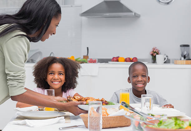 istock Mother bringing fried chicken to the dinner table 463428549