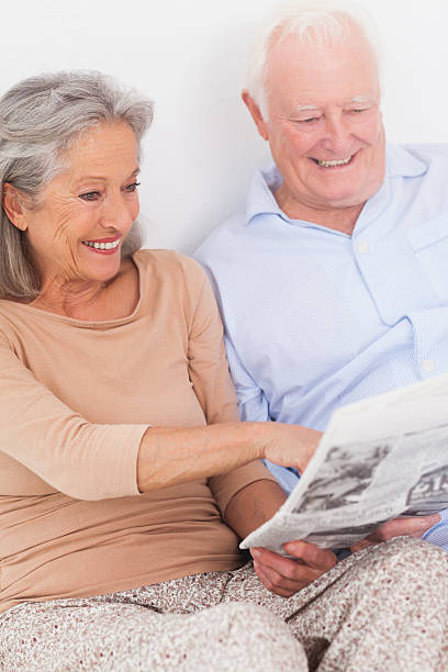 istock Couple reading a newspaper together 463429093