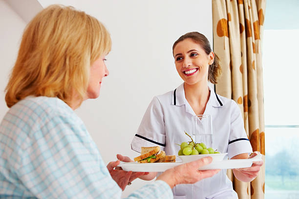 istock Healthcare worker serving breakfast to elderly patient 463432107
