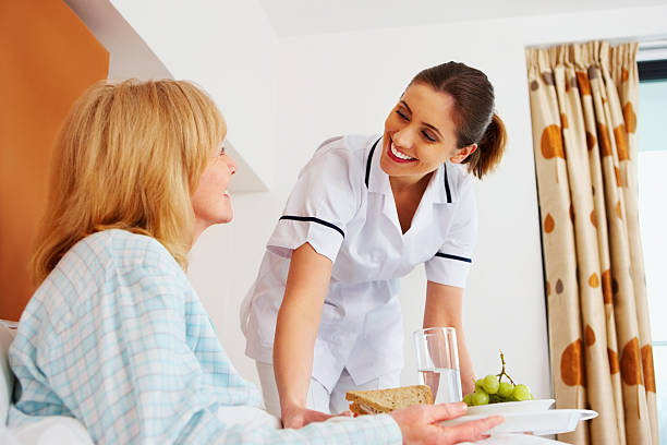 istock Healthcare worker serving breakfast to senior patient 463432437
