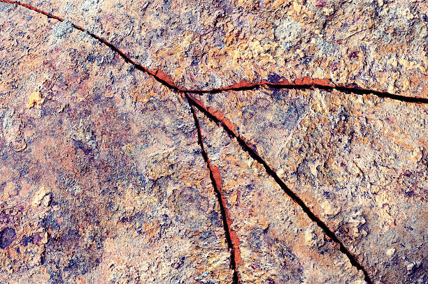 Rusty pipe with a large crack.