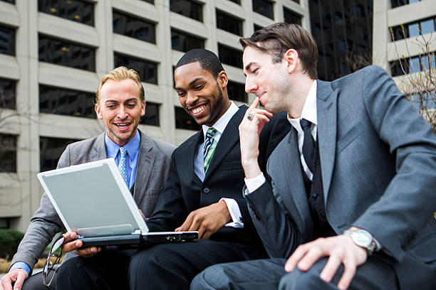 Three Business Colleagues Looking at a Laptop