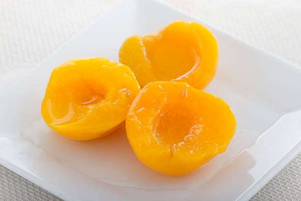 istock Peach halves on the plate. 463439635