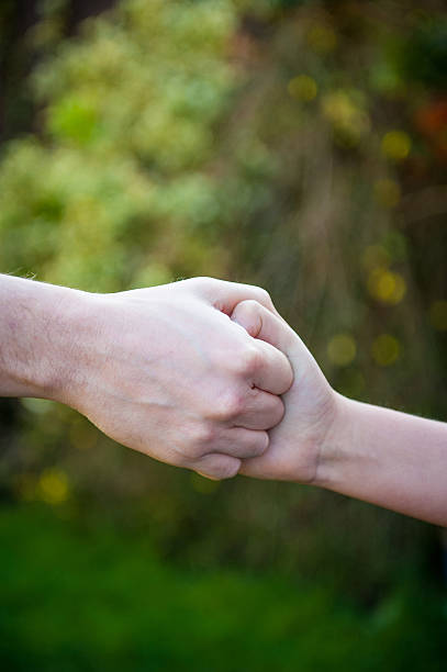 istock Child holding Adult Hand 463439639