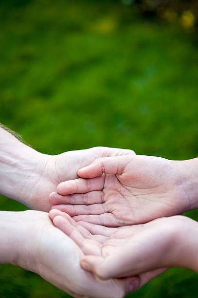 istock Man and child hands cupped together 463439667