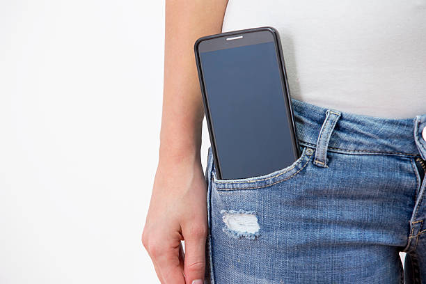 istock Standing woman with Smartphone in jeans pocket 463439977