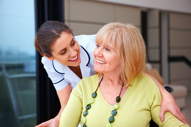 istock Young nurse with senior woman 463440035