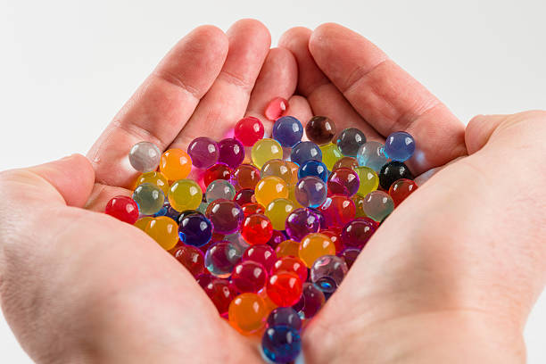 istock Hands Holding Round Colorful Balls 463440461