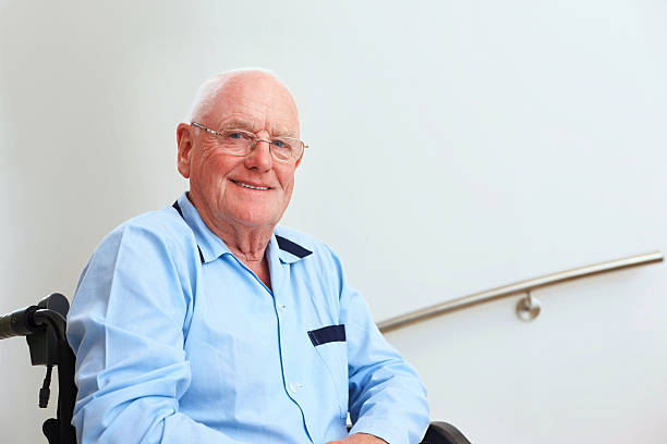 istock Happy senior man sitting in wheelchair 463440509