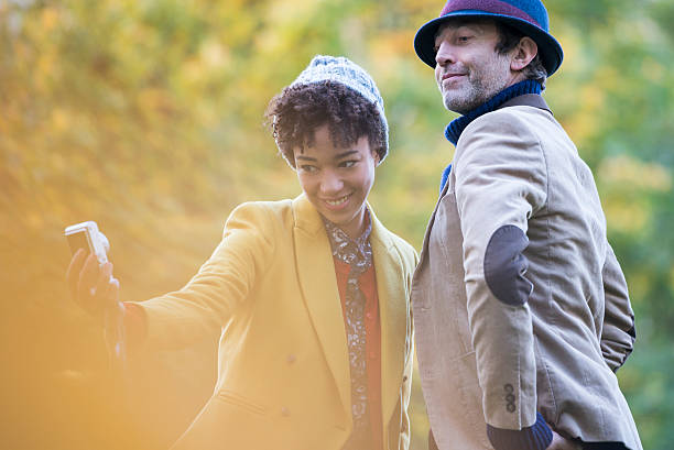 Couple taking a Selfie in an autumn Park.