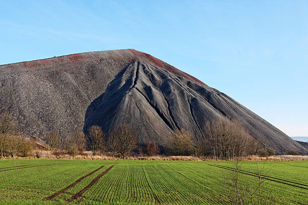slag heap slag heap with green field in germany slag heap stock pictures, royalty-free photos & images
