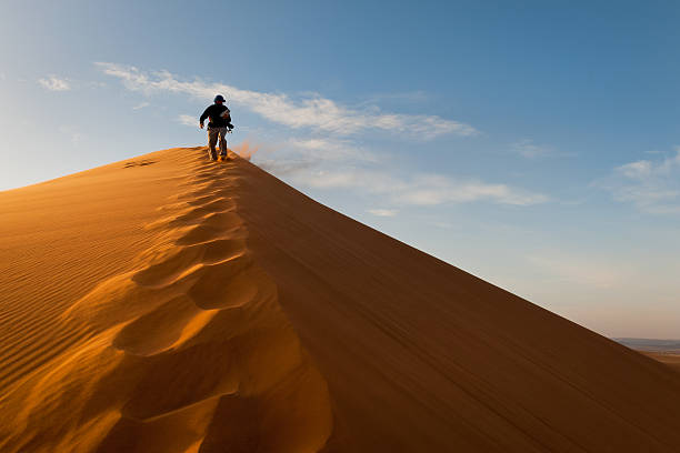 istock Man on Erg Chebbi Sand Dune at Sunrise, Morocco, Africa 463444829