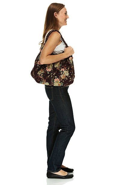 istock Smiling young girl standing with handbag 463447201