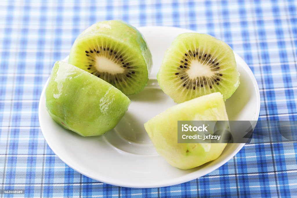 kiwi fruit on white dish kiwi  fruit  slice on white dish on tablecloth Art And Craft Stock Photo