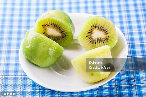 Kiwi Fruit On White Dish Stock Photo - Download Image Now - Art And Craft, Black Color, Blue