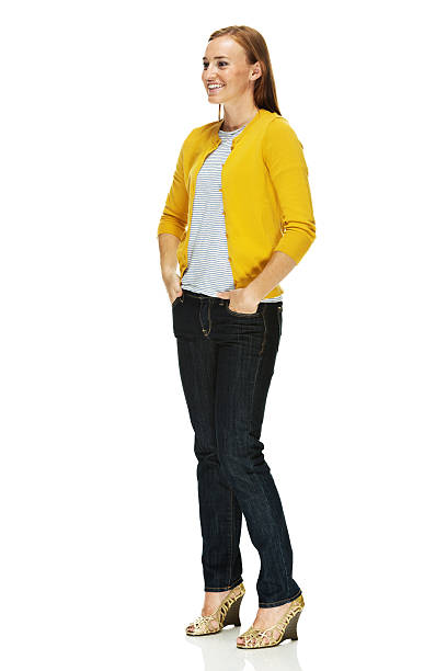 istock Smiling woman standing with hands in pockets 463452003