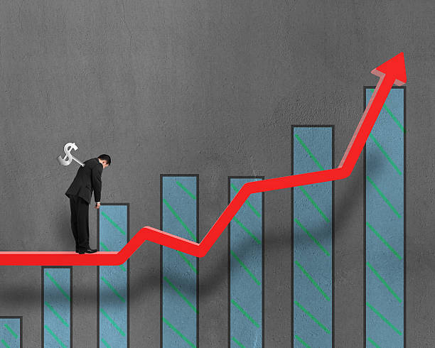 istock Winder on businessman's back with growing red arrow and chart 463455653