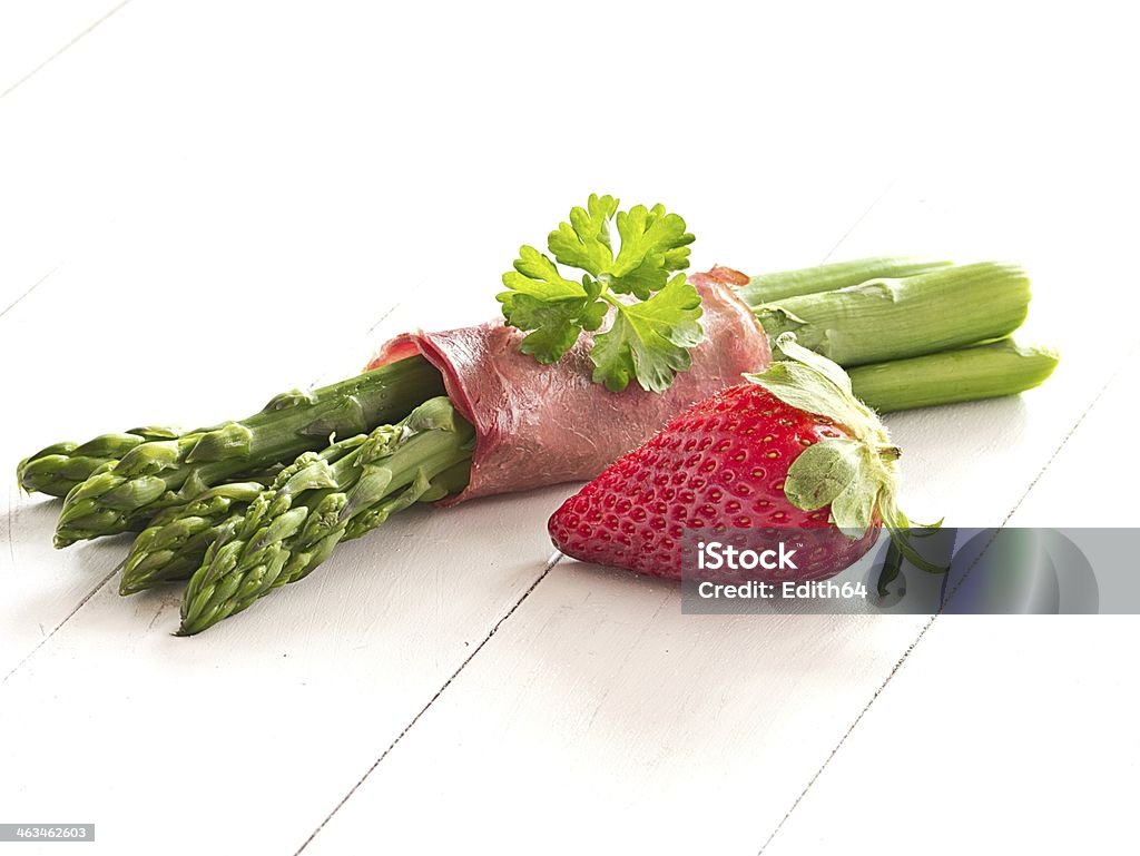 Green asparagus with a strawberry Green asparagus, cooked with ham Asparagus Stock Photo