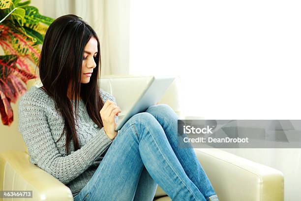 Beautiful Woman Sitting On The Armchair With Tablet Computer Stock Photo - Download Image Now