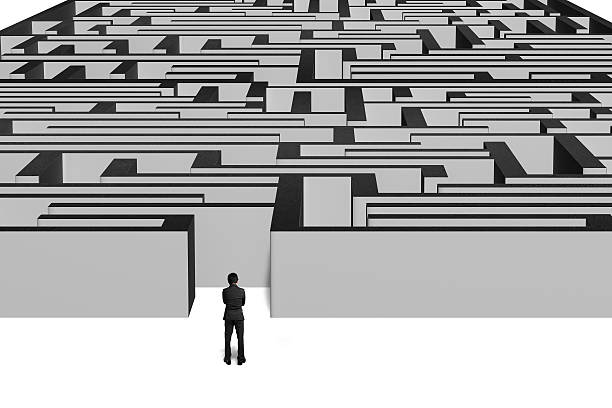 istock Businessman standing in front of maze 463464827