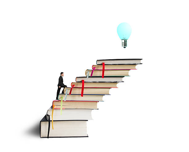 istock Businessman climbing on stack of books with growing bulb 463467899