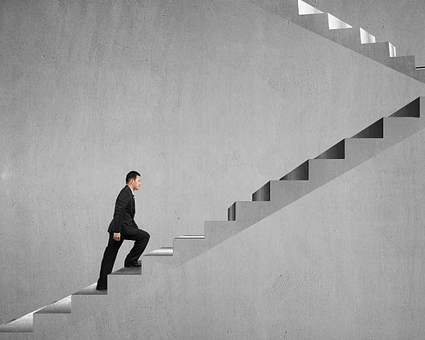 istock Businessman climbing on concrete stairs 463468147