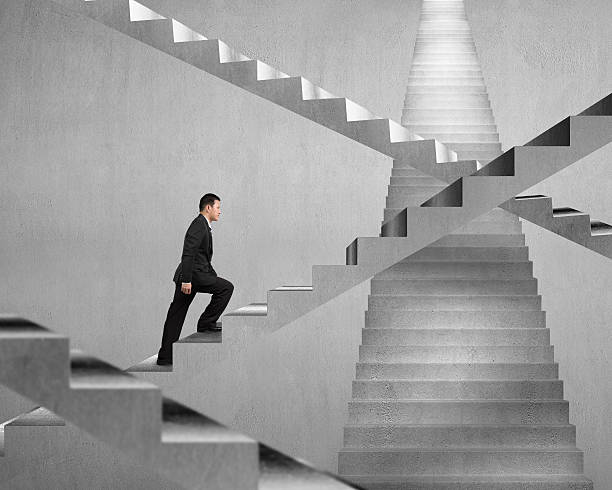 istock Businessman climbing on concrete stair maze 463469599