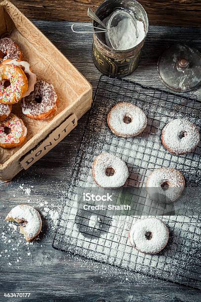 Tasting Sweet Donuts With Icing Sugar Stock Photo - Download Image Now - Arrangement, Bakery, Black Color