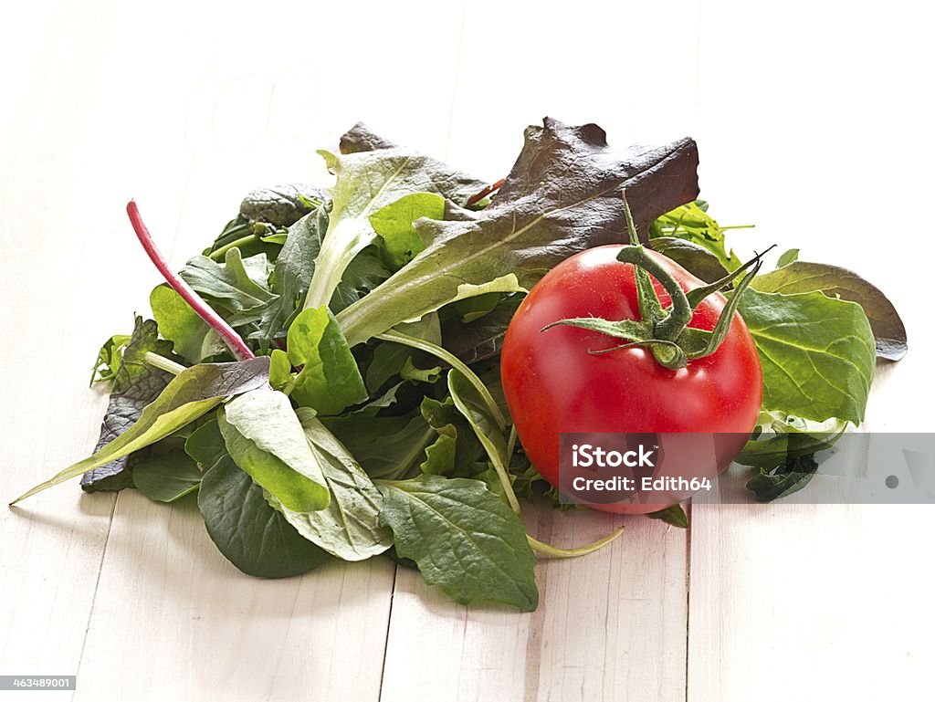 Leaf salad with a tomato Italian picking salad and tomatoes Arugula Stock Photo
