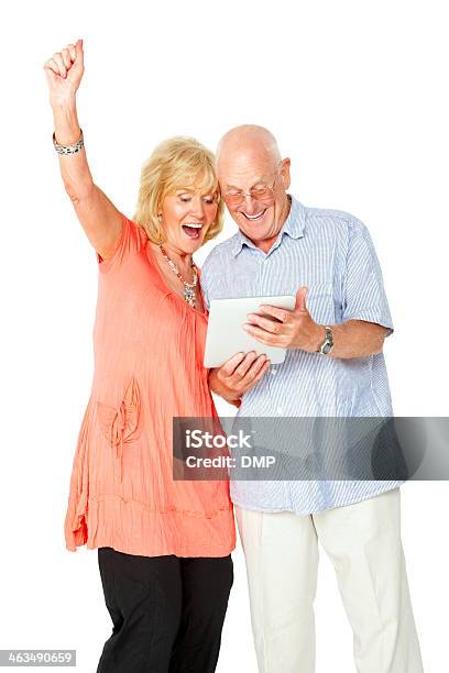 Foto de Casal Sênior Olhando No Tablet Digital Empolgados e mais fotos de stock de Mesa digital - Mesa digital, Mulheres Idosas, 60 Anos