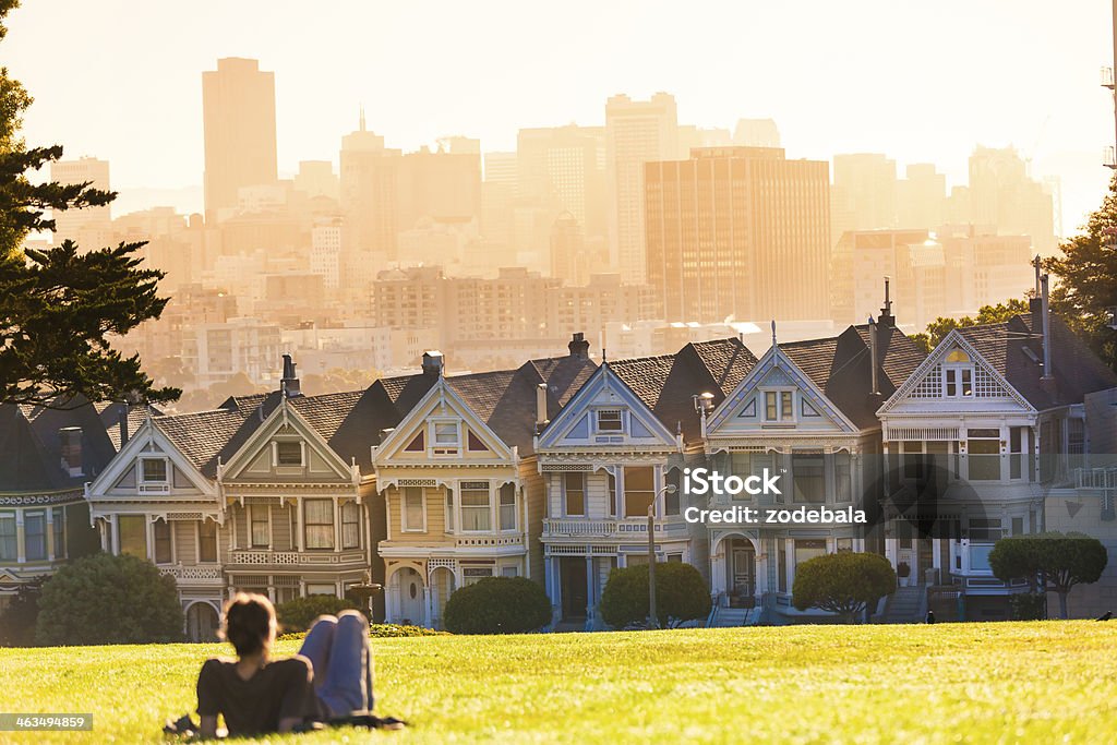 Uomo godendo vista in San Francisco Alamo Square al tramonto - Foto stock royalty-free di Estate