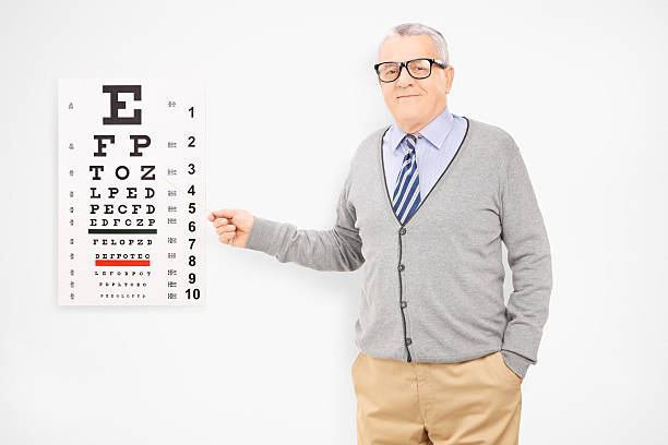 istock Mature man with glasses pointing towards eyesight test 463496383