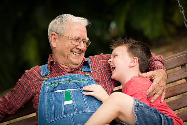 istock Young Boy Laughing With His Great Grandfather 463496545